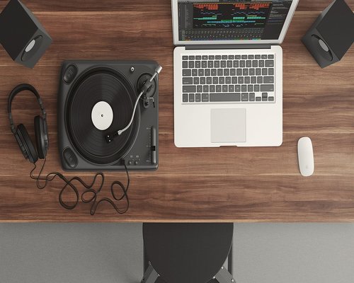 An editorial workspace table containing a notebook and filtered light